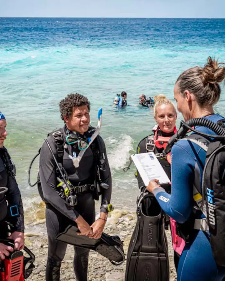 Instructeur de plongée en briefing avec ses élèves
